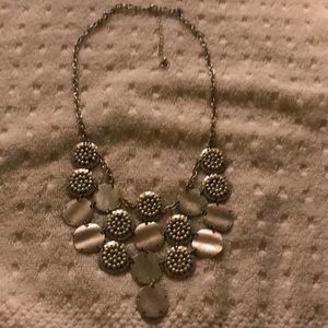 A sliver necklace with no earrings